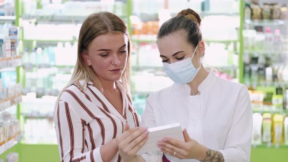 Professional Pharmacist Helping Her Female Customer Choosing Products at the Drugstore