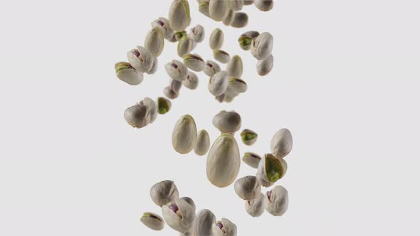 Falling of Roasted Pistachios in White Background