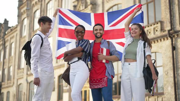 Group of Proud Multiethnic Students Posing with British Flag at University Campus