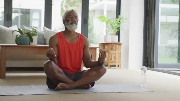 Video of african american senior man meditating