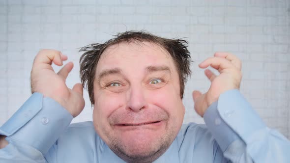 Portrait of upset man tearing hair on his head in tantrum in office