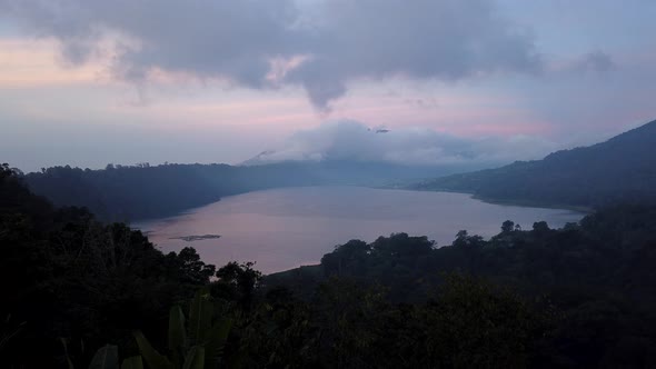 Twin lakes view point day to night time lapse. Tamblingan Lake, Buyan Lake. Running clouds pink sky