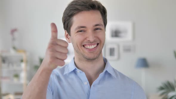 Thumbs Up By Excited Handsome Young Man