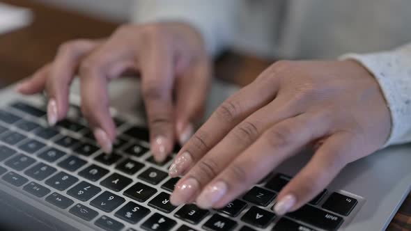 Top View of African Woman Hands Typing on Laptop