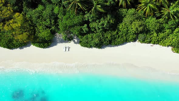 Wide aerial abstract view of a white paradise beach and turquoise sea background in colorful 4K