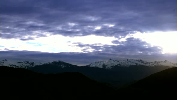Mountain with Snowy Peaks and Clouds