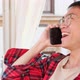 Asian Man Holding Smartphone and Talking By Phone with Friend Smiling and Laughing Outdoor - VideoHive Item for Sale
