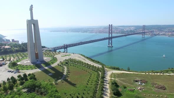 Aerial view of Sanctuary of Christ the King overlooking Lisbon and 25 de Abril Bridge connecting Lis