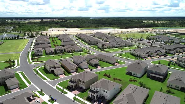 Aerial view of an upper middle class lakefront neighborhood subdivision with single family homes and