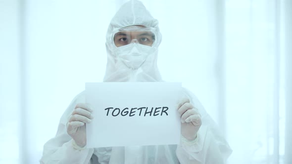 The doctor in PPE suit show text together for Covid-19 Corona virus 