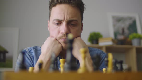 A Young Handsome Guy is Thinking About the Next Move in a Difficult Game