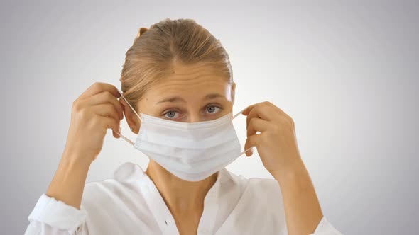 Business Lady Walking and Putting Medical Mask on on Gradient Background