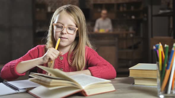 Cheerful Girl Writing Her Homework for School