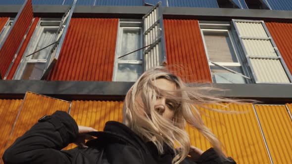 Woman grunge standing at a colorful building