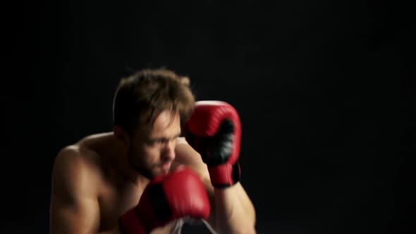 Handsome Fighter in Red Gloves Is Boxing.