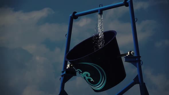 Water Park a Bucket of Water Turns Over. Slow Motion. Close Up