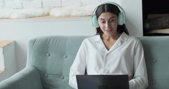 Young Woman Studying Online Using Laptop and Video Call with Teacher and Learning