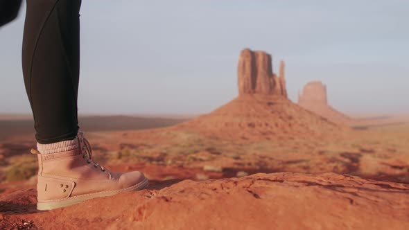 Closeup Woman Legs in Pink Hiking Boots Walking By Red Desert in Monument Valley