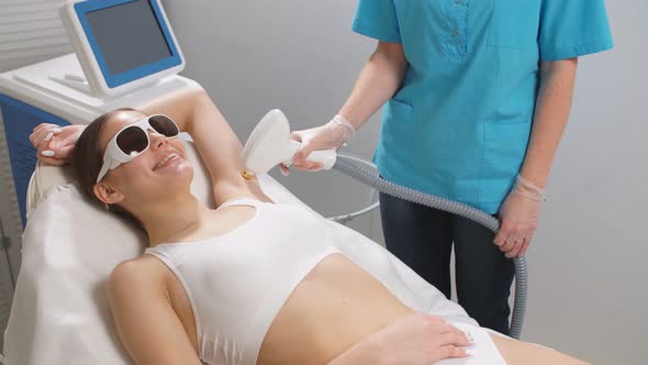 Skin Care Concept. Young Woman Get Laser Epilation Procedure.