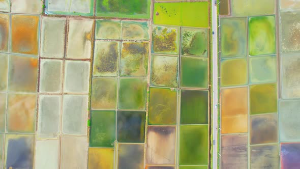 An aerial view from a drone flying over a salt fields, salt production.