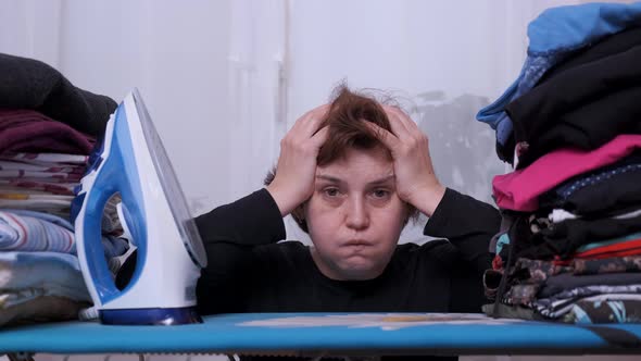 Woman Tired Ironed Clothes at Home