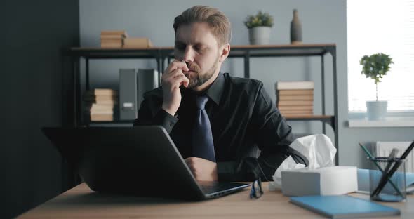 Man with Running Nose Using Spray in Office