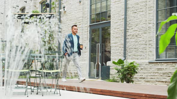 Young successful caucasian businessman works outdoor