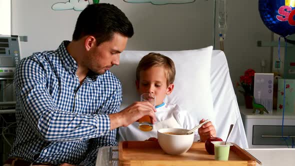 Father feeding breakfast to his son