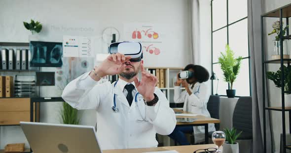 Multiracial Male and Female Doctors Working on Virtual Screen in Special 3d Glasses