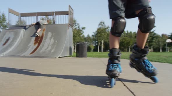 Boy Rollerblading at park, closeup of feet