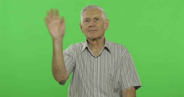 Senior Man Waving Hands To Camera. Handsome Old Man on Chroma Key Background