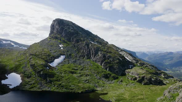 Cinematic aerial shot of Storehorn Peak in Hemsedal, Norway. Wide shot rising up, flying over the pe