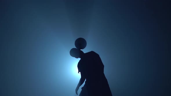 Football Player Is Stuffing Ball on His Shoulder in Twilight