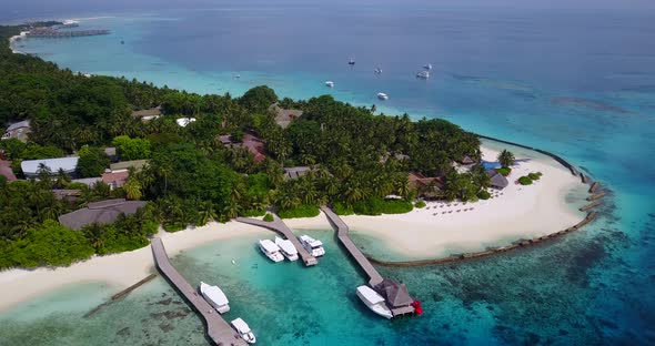 Wide birds eye abstract shot of a paradise sunny white sand beach and aqua blue water background in 