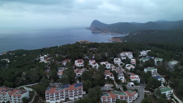Hotels in Ibiza Spain on a Beautiful Mountain Side - Forwarding Aerial Shot