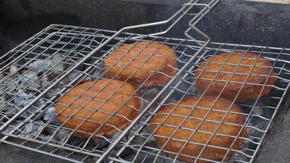 Closeup of Hamburger Patties on the Grill is Fried in the Fresh Air