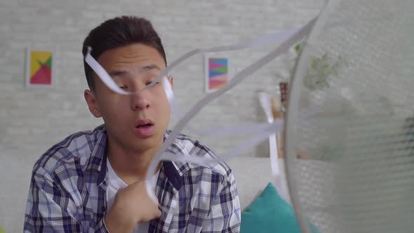 Saddened Young Asian Man Saved From the Heat Sitting in Front of a Working Fan Slow Mo