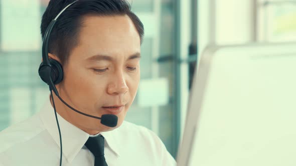 Businessman Wearing Headset Working Actively in Office