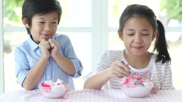 Happy Little Asian Children  Eating Ice Cream At Home