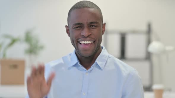 Portrait of African Man Waving Welcoming in Office
