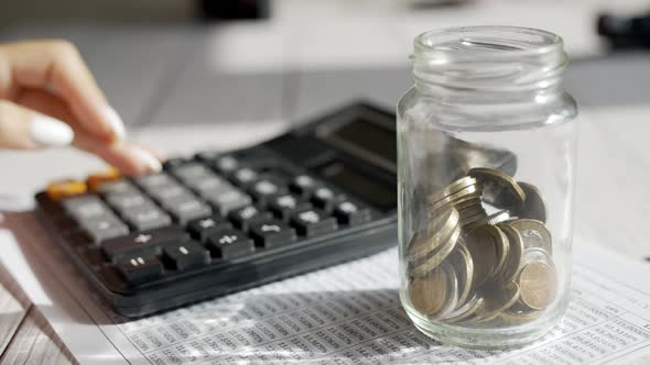 A Woman is Calculating Her Expenses for a Month