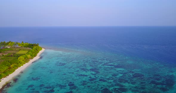 Beautiful flying abstract view of a paradise sunny white sand beach and aqua blue ocean background i