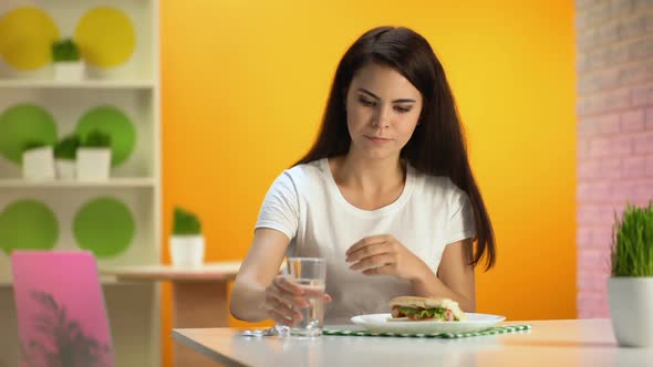 Smiling Lady Taking Supplement Pill Before Meal and Showing Thumbs Up, Gastritis