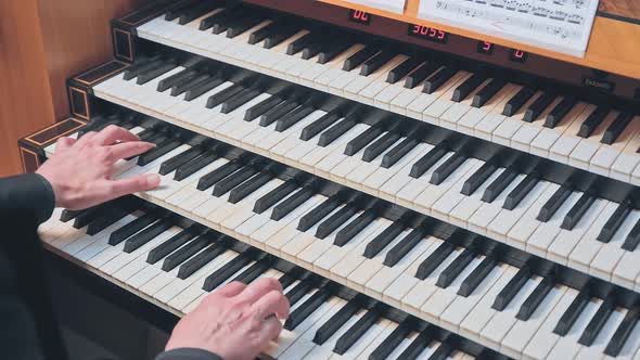 Organist Plays Music on Church Organ