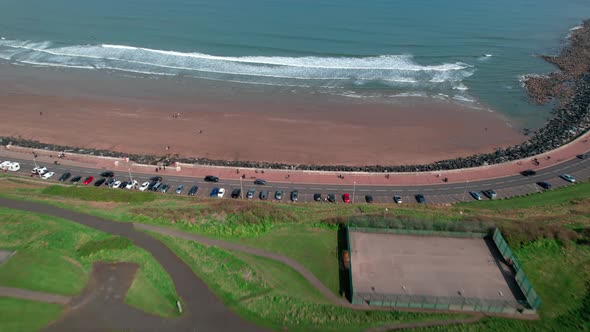 Flying Towards Royal Albert Drive On Scarborough North Bay Beach In North Yorkshire, England. Aerial