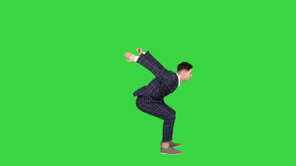 Businessman Makes a Back Flip and Shows Cool Gesture To Camera After on a Green Screen, Chroma Key.
