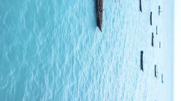 Vertical Video Boats in the Ocean Near the Coast of Zanzibar Tanzania Aerial View