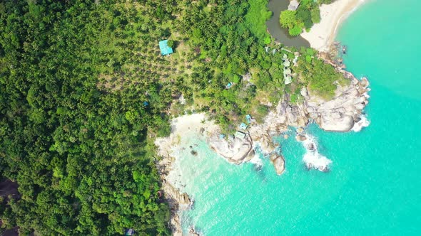 Wide angle aerial island view of a white paradise beach and turquoise sea background in hi res 4K