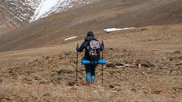 Female Hiker with Backpack Traveling in Mountains