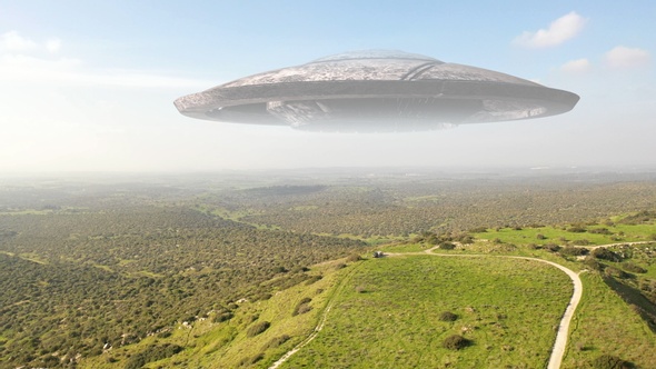 Large alien spaceship saucer hover over mountains, aerial view